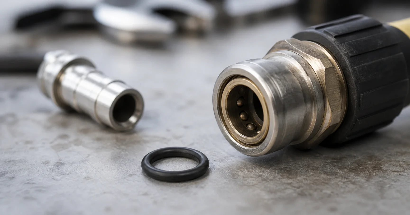 Realistic close-up of a pressure washer quick-connect fitting with a small black O-ring nearby